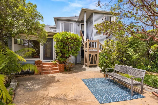 a view of a house with backyard and sitting area