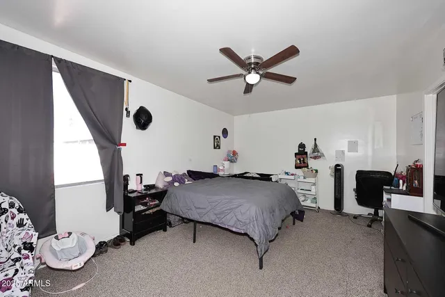 a bedroom with bed and a window