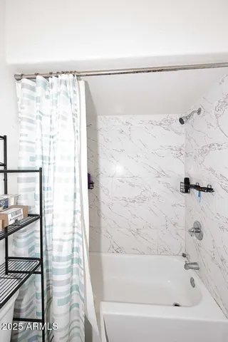 a bathroom with a bathtub and shower