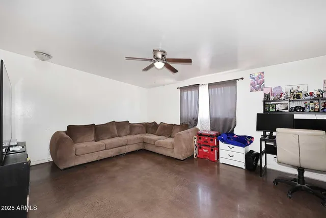 a living room with furniture and kitchen view