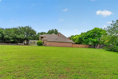a backyard of a house with lots of green space and garden