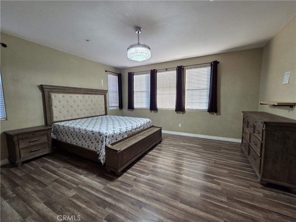 20329 Red Poppy Lane Riverside, CA 92508 - Photo 25 of 31 a bed sitting in a spacious bedroom next to a window and a larger closet