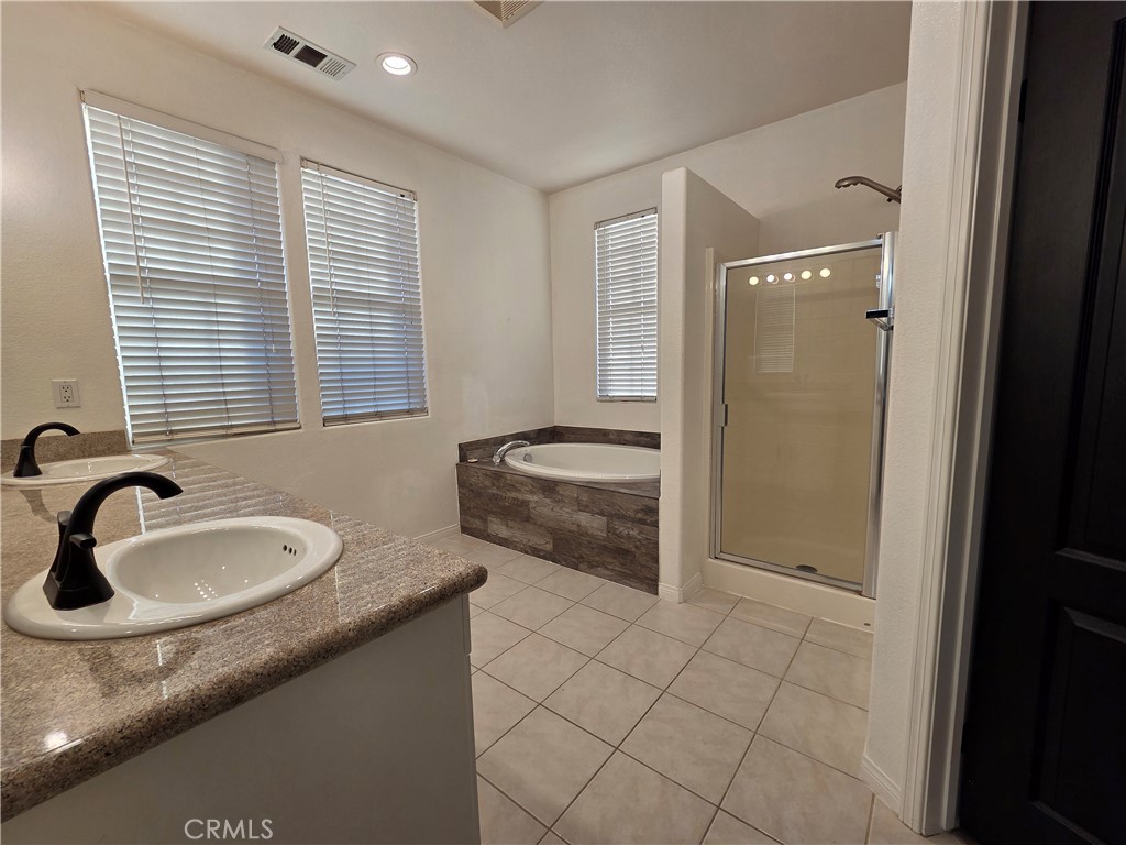 20329 Red Poppy Lane Riverside, CA 92508 - Photo 27 of 31 a bathroom with a granite countertop sink and a mirror