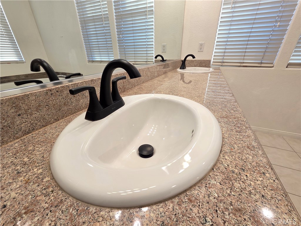 20329 Red Poppy Lane Riverside, CA 92508 - Photo 30 of 31 a bathroom with a sink and a mirror