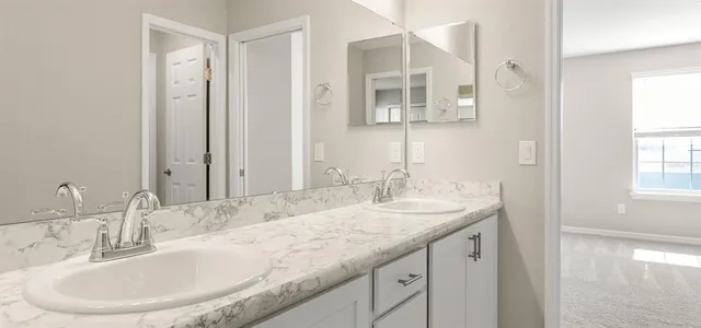 a bathroom with a granite countertop sink and a bathtub