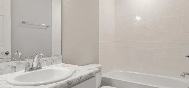 a kitchen with white cabinets sink and stainless steel appliances