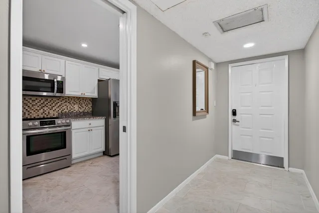 a view of a hallway with wooden shelves