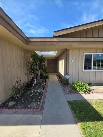 a view of a house with potted plants