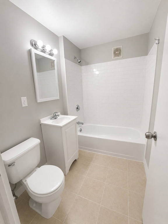 196 Washington Street, Unit 2 Lynn, MA 01902 - Photo 2 of 4 a bathroom with a toilet sink and mirror