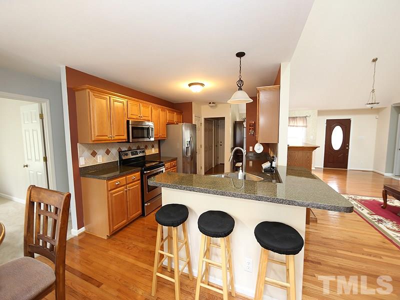 1012 Christy Ridge Court Rougemont, NC 27572 - Photo 6 of 20 a kitchen with a dining table chairs and refrigerator