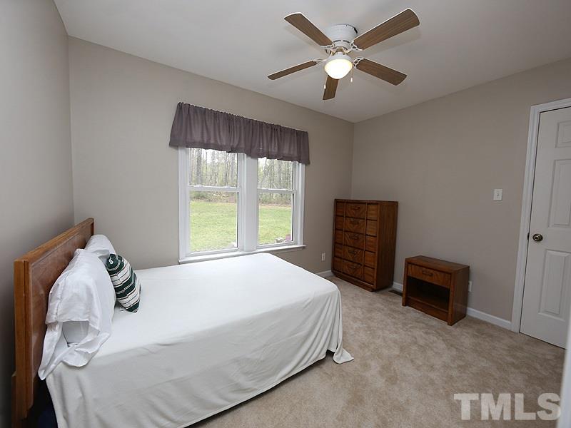 1012 Christy Ridge Court Rougemont, NC 27572 - Photo 10 of 20 a bedroom with a bed and a large window