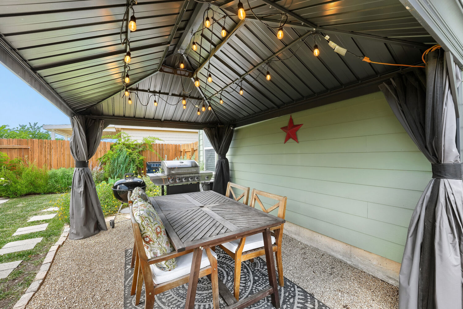 116 Millers Loop Jarrell, TX 76537 - Photo 11 of 23 Relax in this inviting outdoor oasis patio right off of the kitchen, perfect for entertaining under strung lights.
