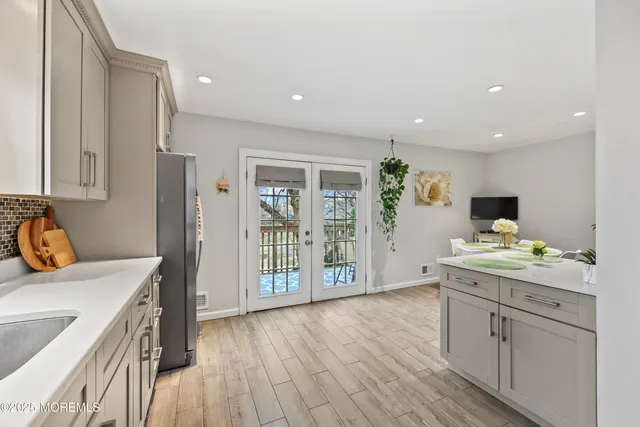 a view of a kitchen with a sink and wooden floor