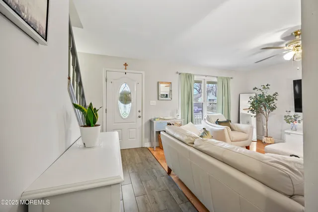 a living room with furniture and a potted plant