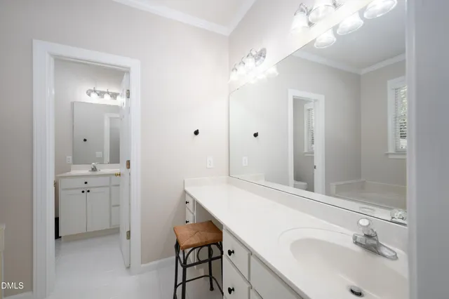 a bathroom with a sink vanity granite tub and shower