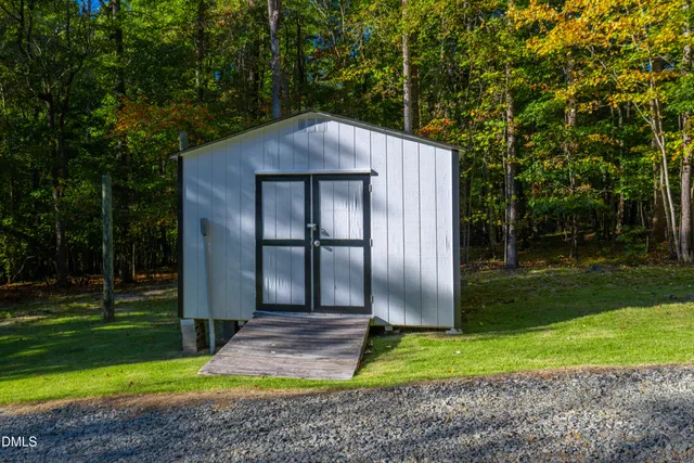 an aerial view of a house with a garden and swimming pool