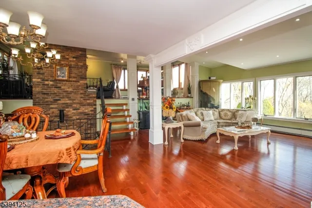 a living room with fireplace furniture and a large window
