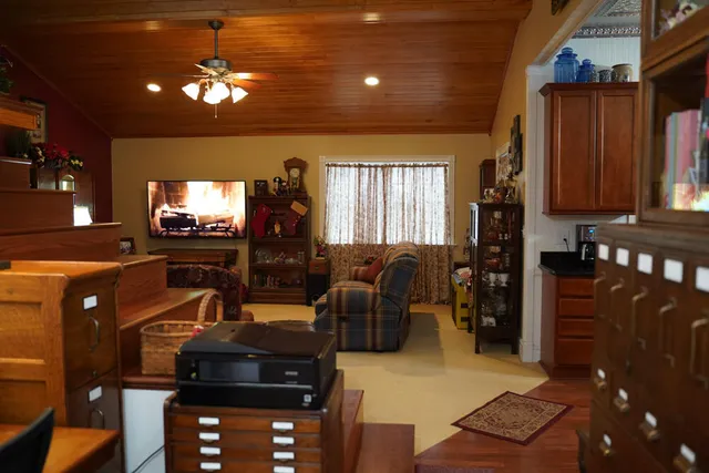 a living room with furniture a lamp and a chandelier
