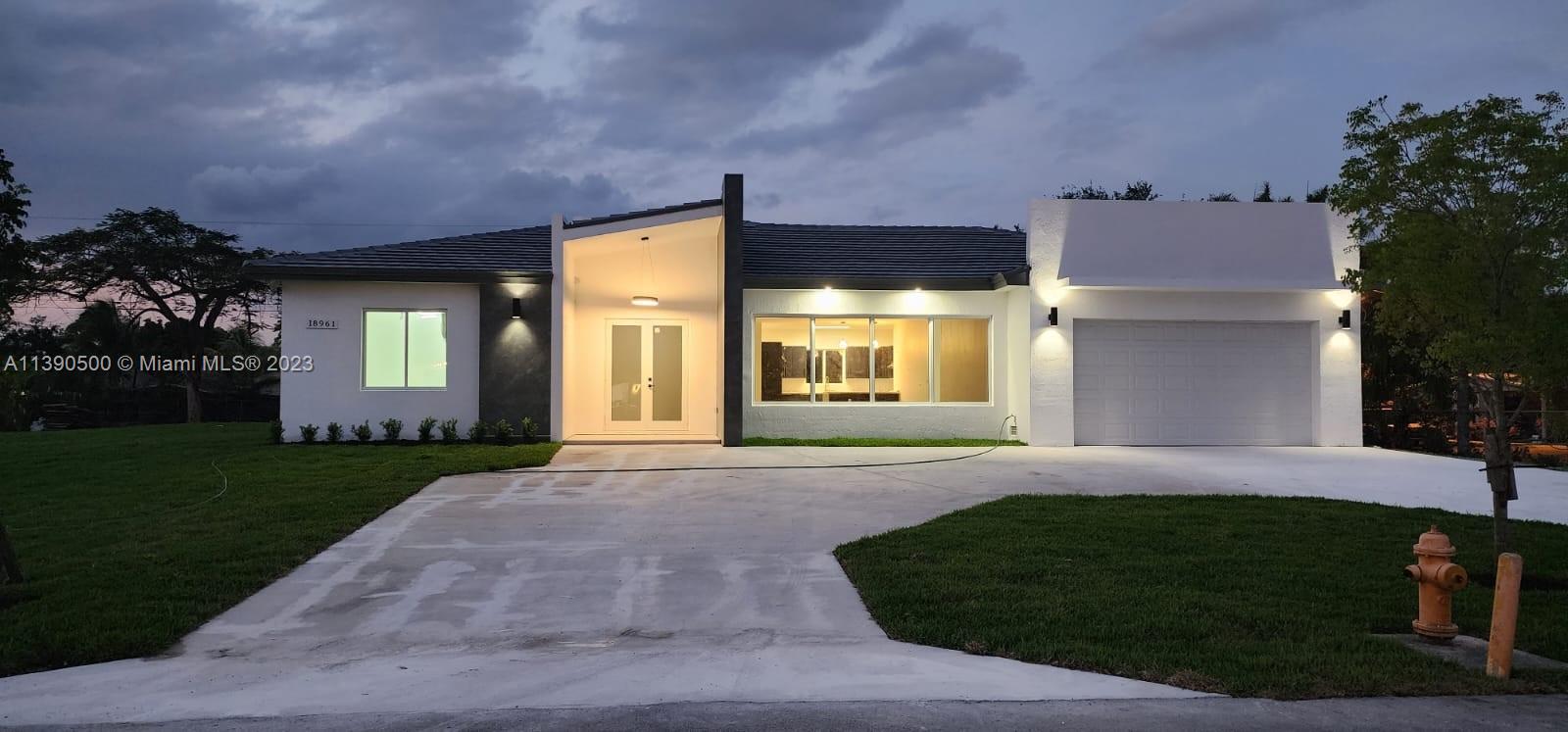 18961 Southwest 359th Street Homestead, FL 33034 - Photo 16 of 54 a front view of a house with a yard and garage
