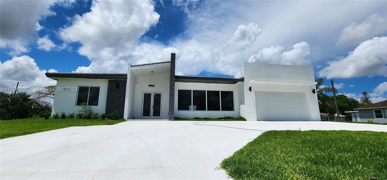 18961 Southwest 359th Street Homestead, FL 33034 - Photo 17 of 54 a front view of a house with a yard