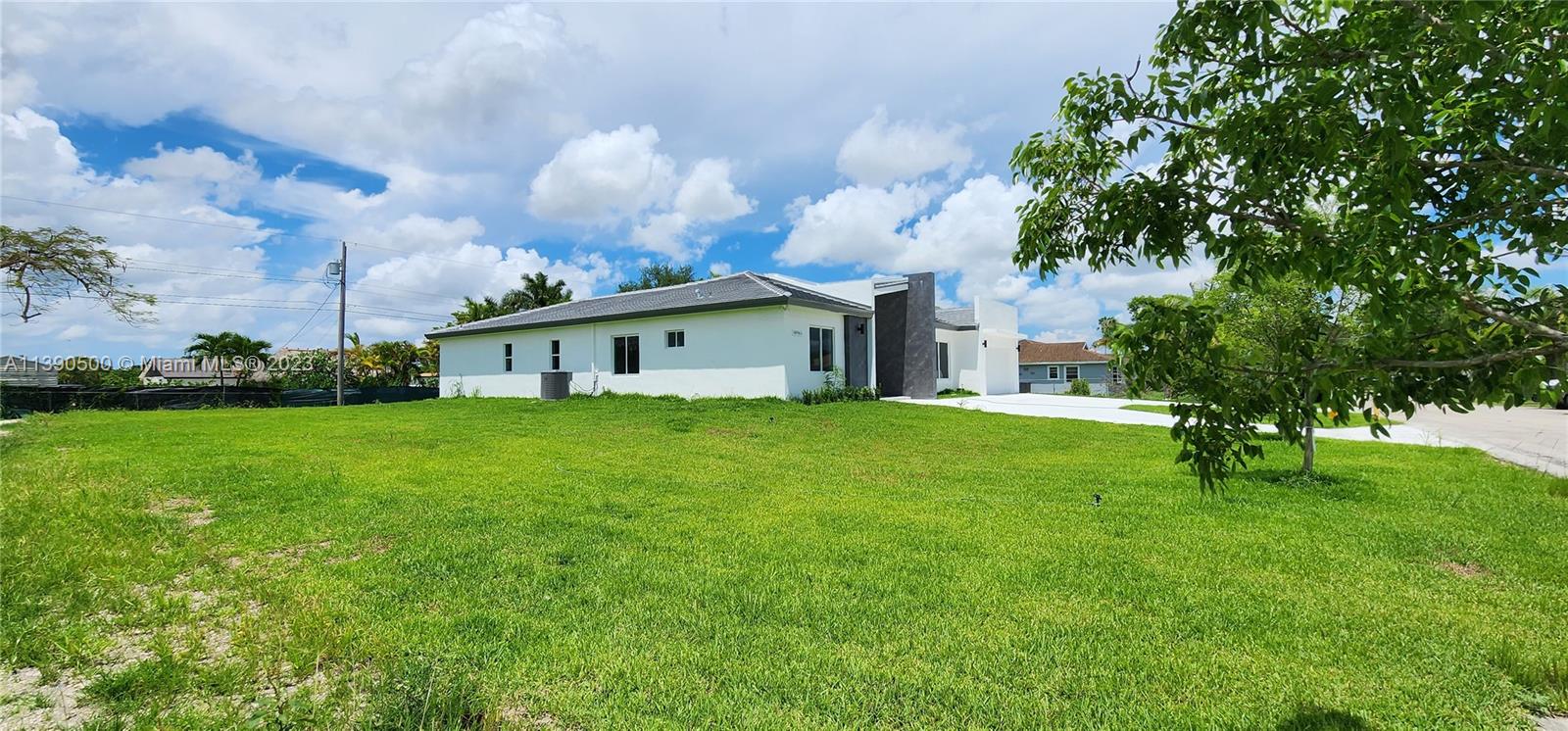 18961 Southwest 359th Street Homestead, FL 33034 - Photo 18 of 54 a front view of house with garden and trees