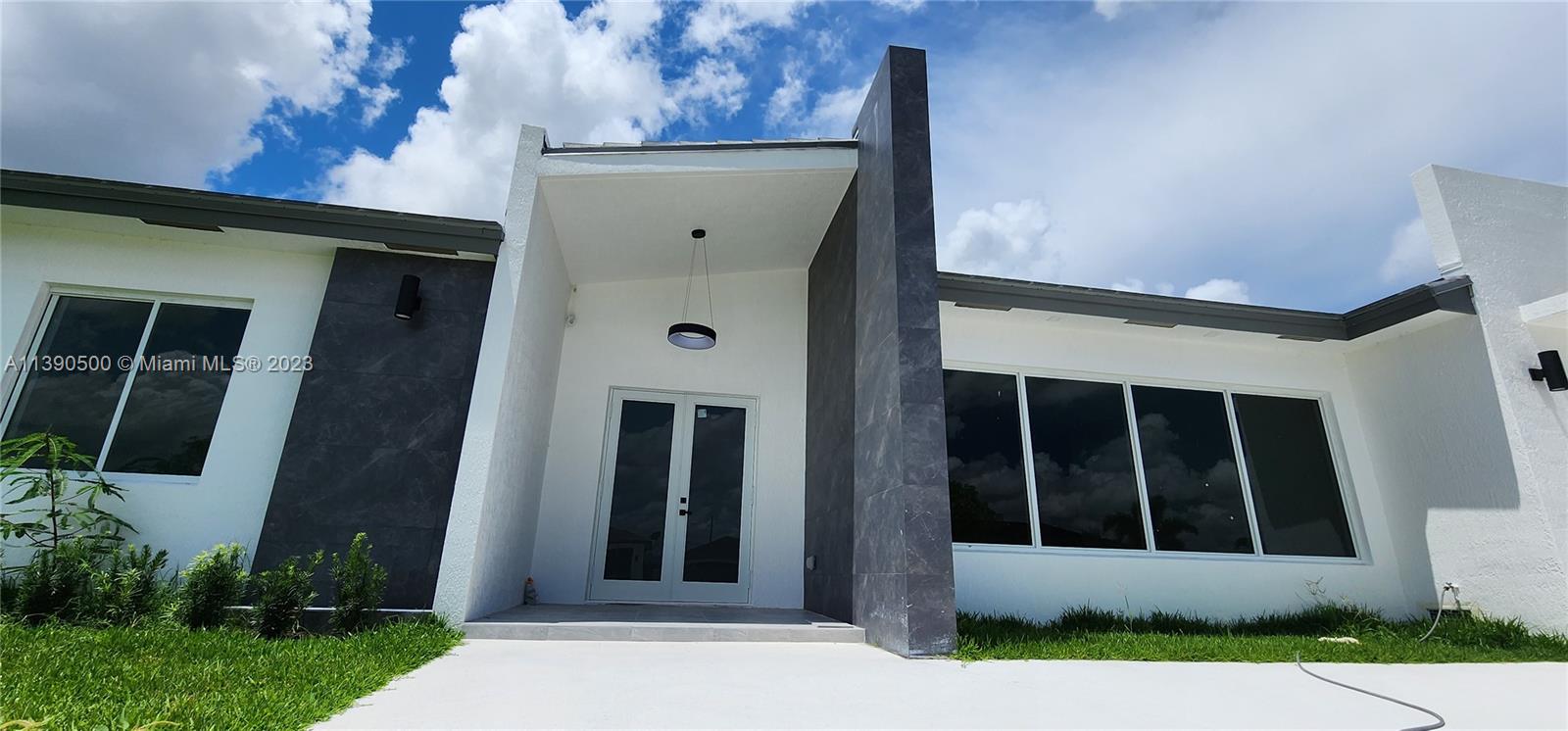 18961 Southwest 359th Street Homestead, FL 33034 - Photo 19 of 54 a front view of a house with a yard