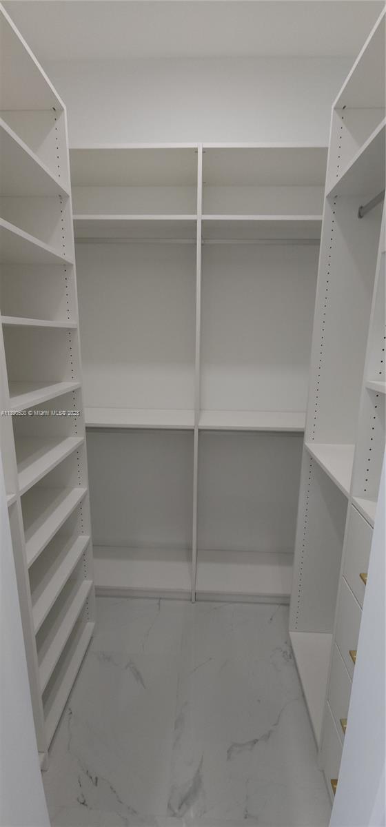18961 Southwest 359th Street Homestead, FL 33034 - Photo 27 of 54 a view of walk in closet with empty racks