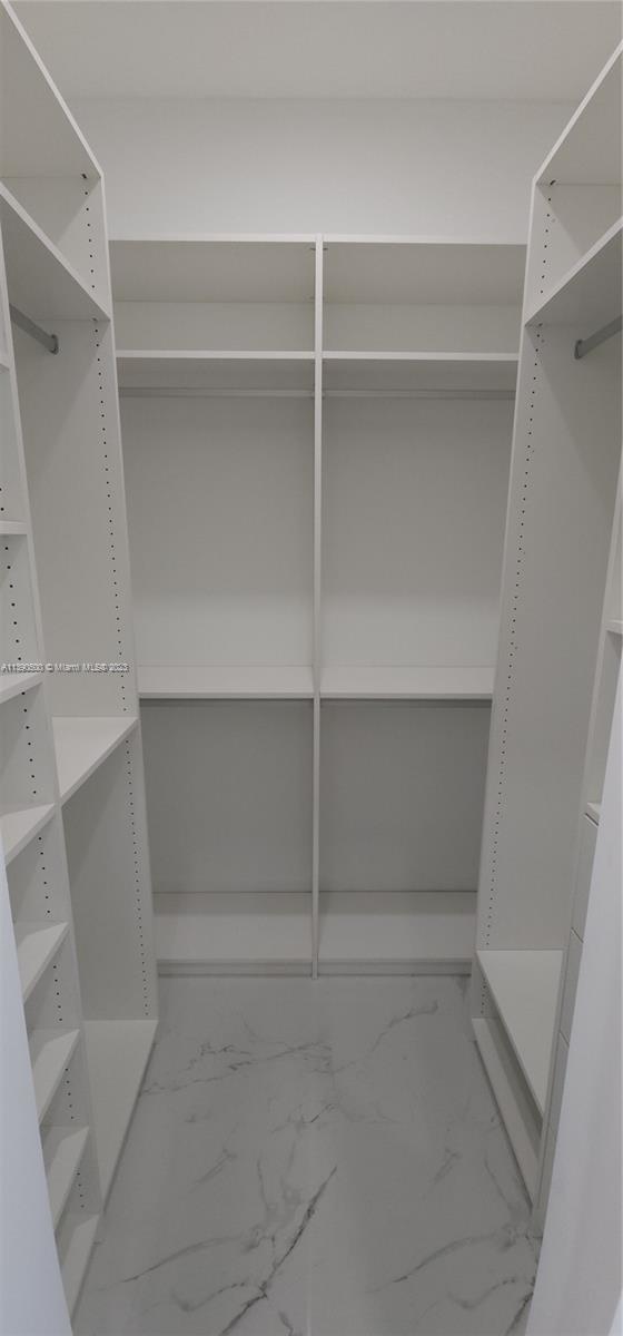 18961 Southwest 359th Street Homestead, FL 33034 - Photo 28 of 54 a view of walk in closet with empty racks