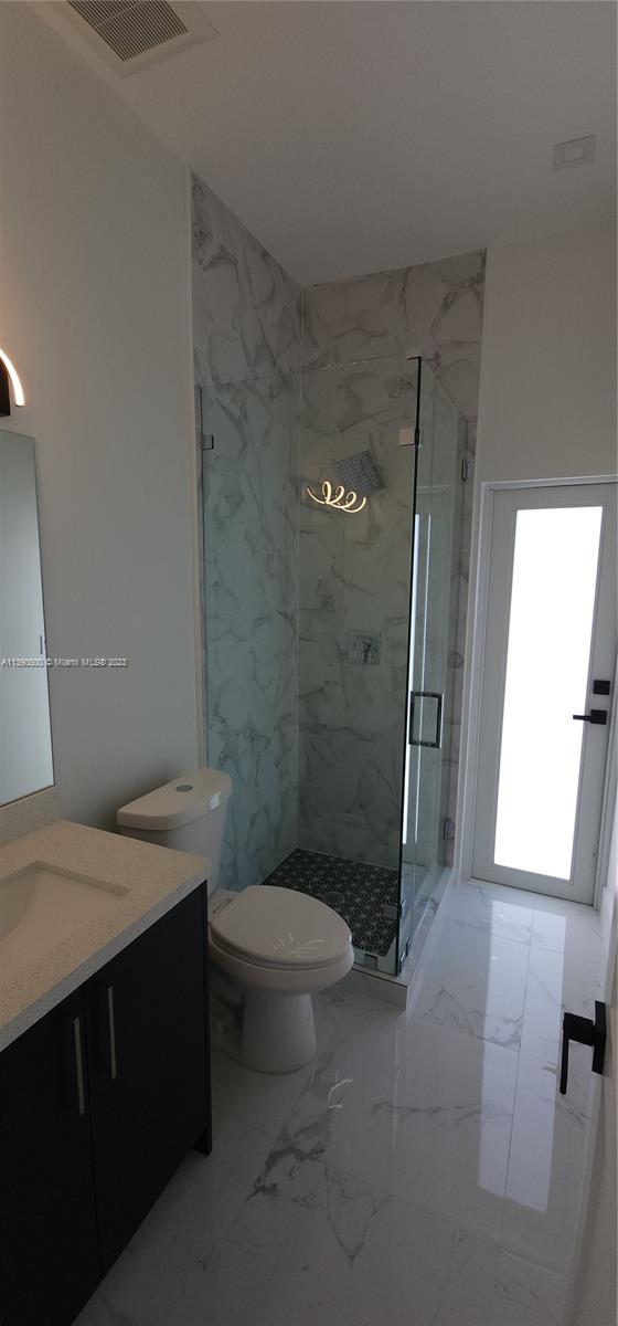18961 Southwest 359th Street Homestead, FL 33034 - Photo 36 of 54 a bathroom with a sink a toilet and shower