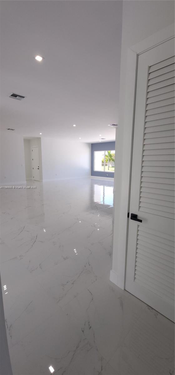 18961 Southwest 359th Street Homestead, FL 33034 - Photo 38 of 54 wooden floor in an empty room with a window