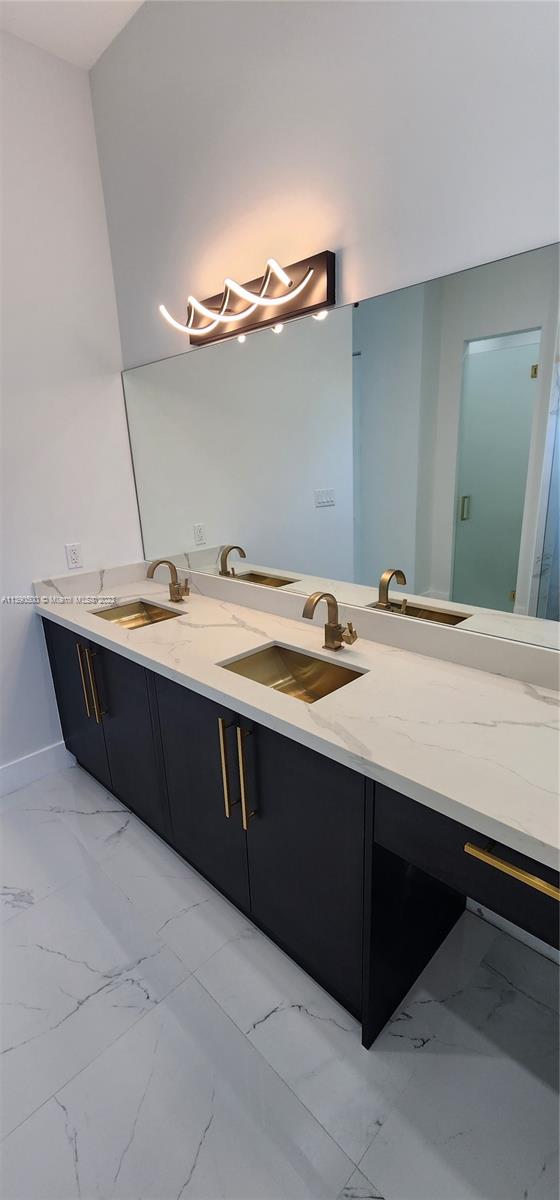 18961 Southwest 359th Street Homestead, FL 33034 - Photo 41 of 54 a room with a sink vanity and mirror