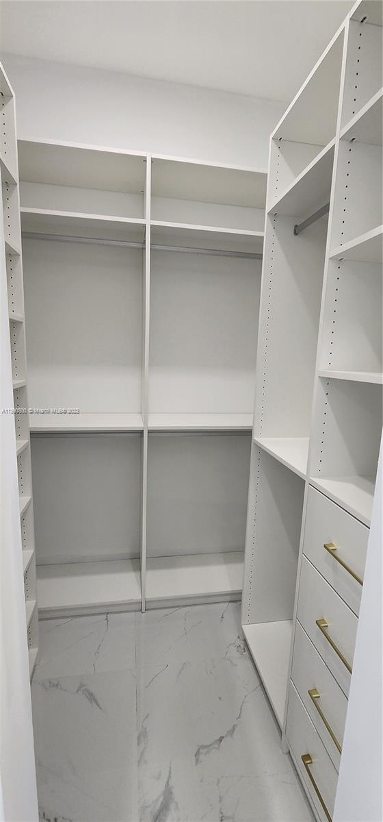 18961 Southwest 359th Street Homestead, FL 33034 - Photo 42 of 54 a view of walk in closet with empty racks