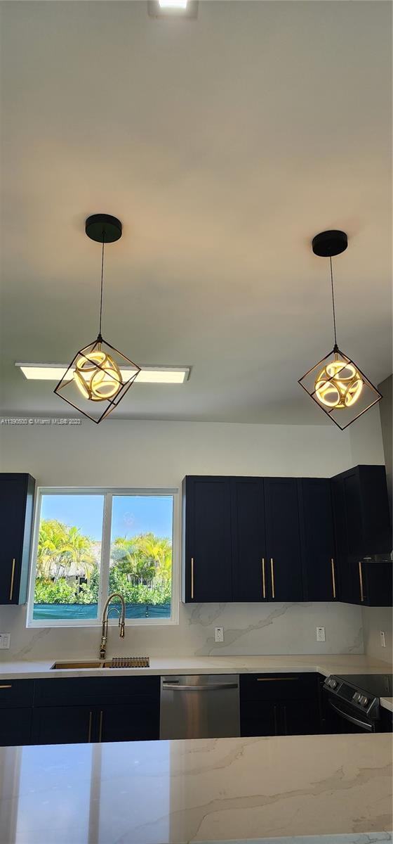18961 Southwest 359th Street Homestead, FL 33034 - Photo 50 of 54 a view of a room with a large window and chandelier
