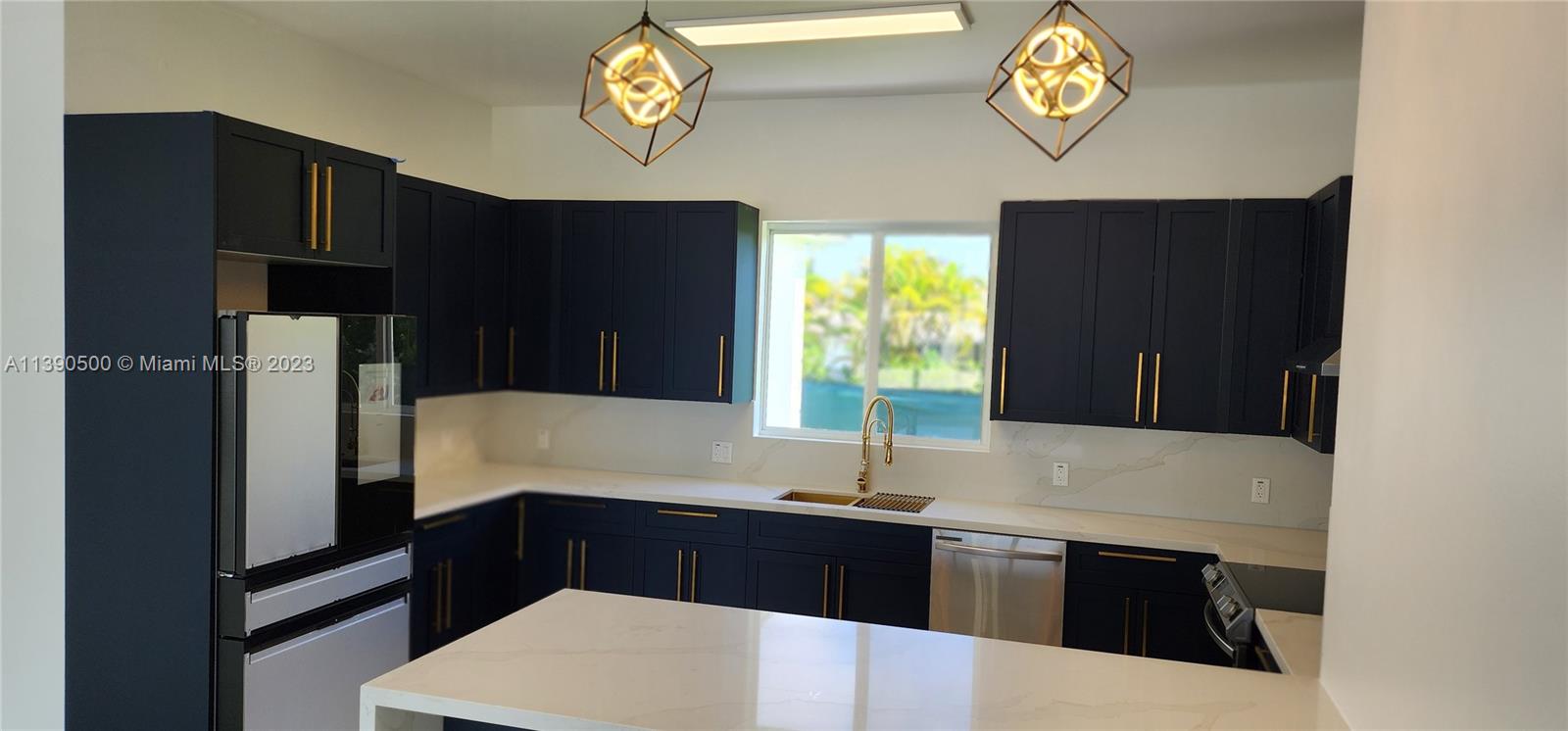 18961 Southwest 359th Street Homestead, FL 33034 - Photo 7 of 54 a kitchen with a sink and a refrigerator