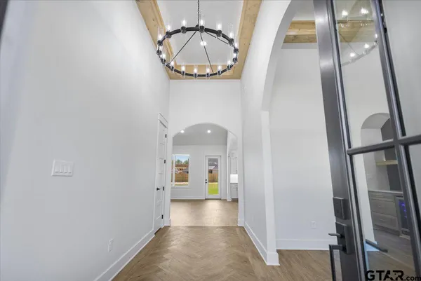 a view of a hallway of a livingroom with furniture