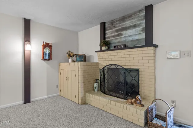 a kitchen with stainless steel appliances kitchen island granite countertop a table chairs microwave and refrigerator