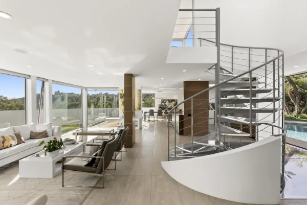 a living room with patio furniture and a floor to ceiling window
