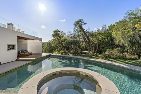 a backyard of a house with fire pit and outdoor seating