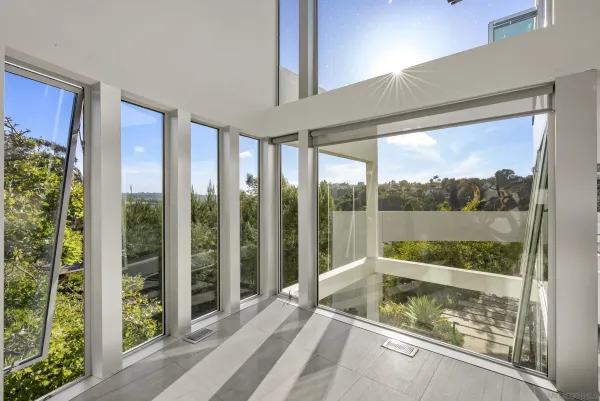 a view of a porch with a floor to ceiling window and a balcony