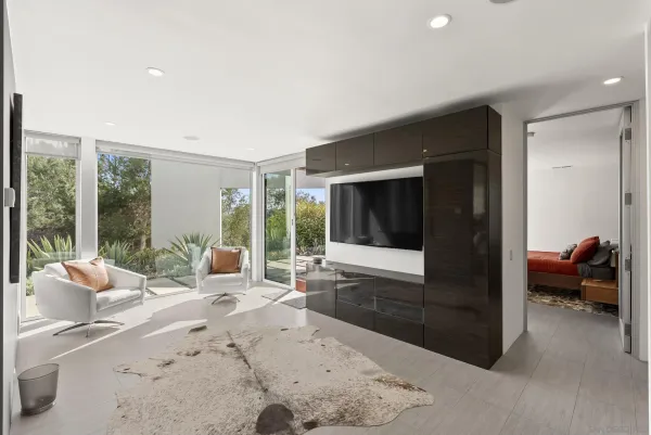 a bedroom with a bed and large window