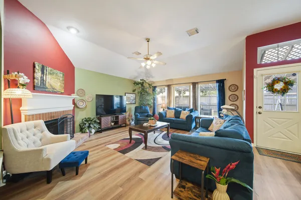 a living room with fireplace furniture and a flat screen tv
