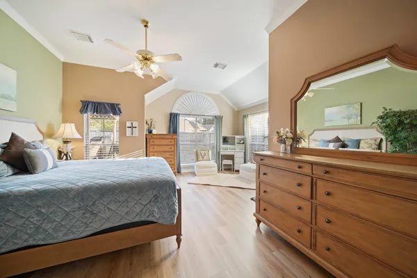a bedroom with a large bed and a chandelier
