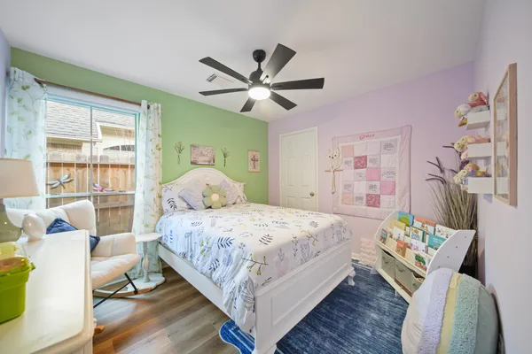 a bedroom with a bed and wooden floor