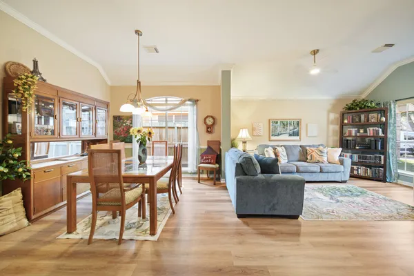 a living room with furniture a wooden floor and a chandelier