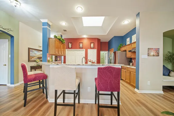 a dining room with furniture and wooden floor