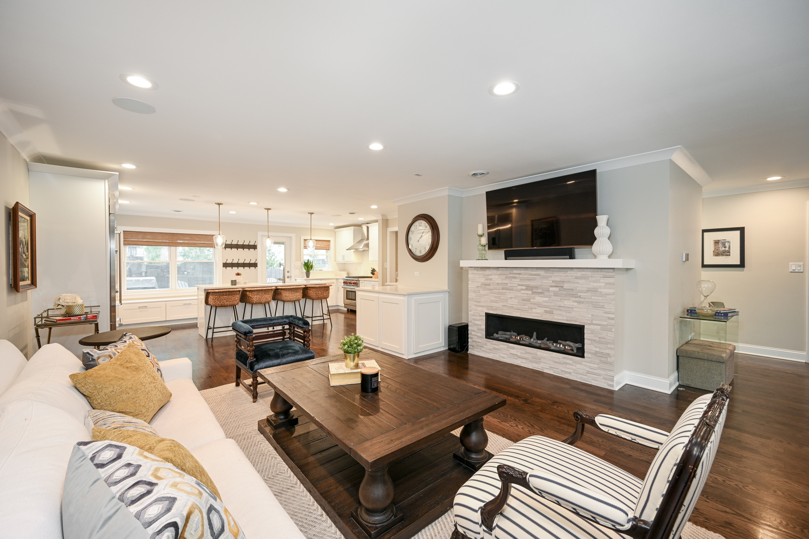 530 Anthony Street, Unit 530 Glen Ellyn, IL 60137 - Photo 4 of 25 a living room with furniture a fireplace a flat screen tv and kitchen view
