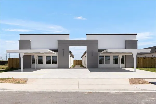 a view of a white house with a outdoor space