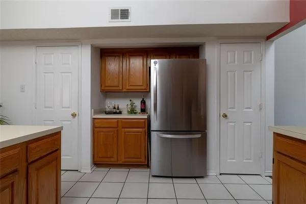 a kitchen with a refrigerator sink and cabinets