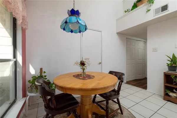 a view of a dining room with furniture and front door