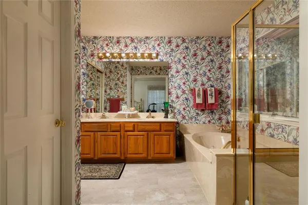 a bathroom with a tub sink and mirror